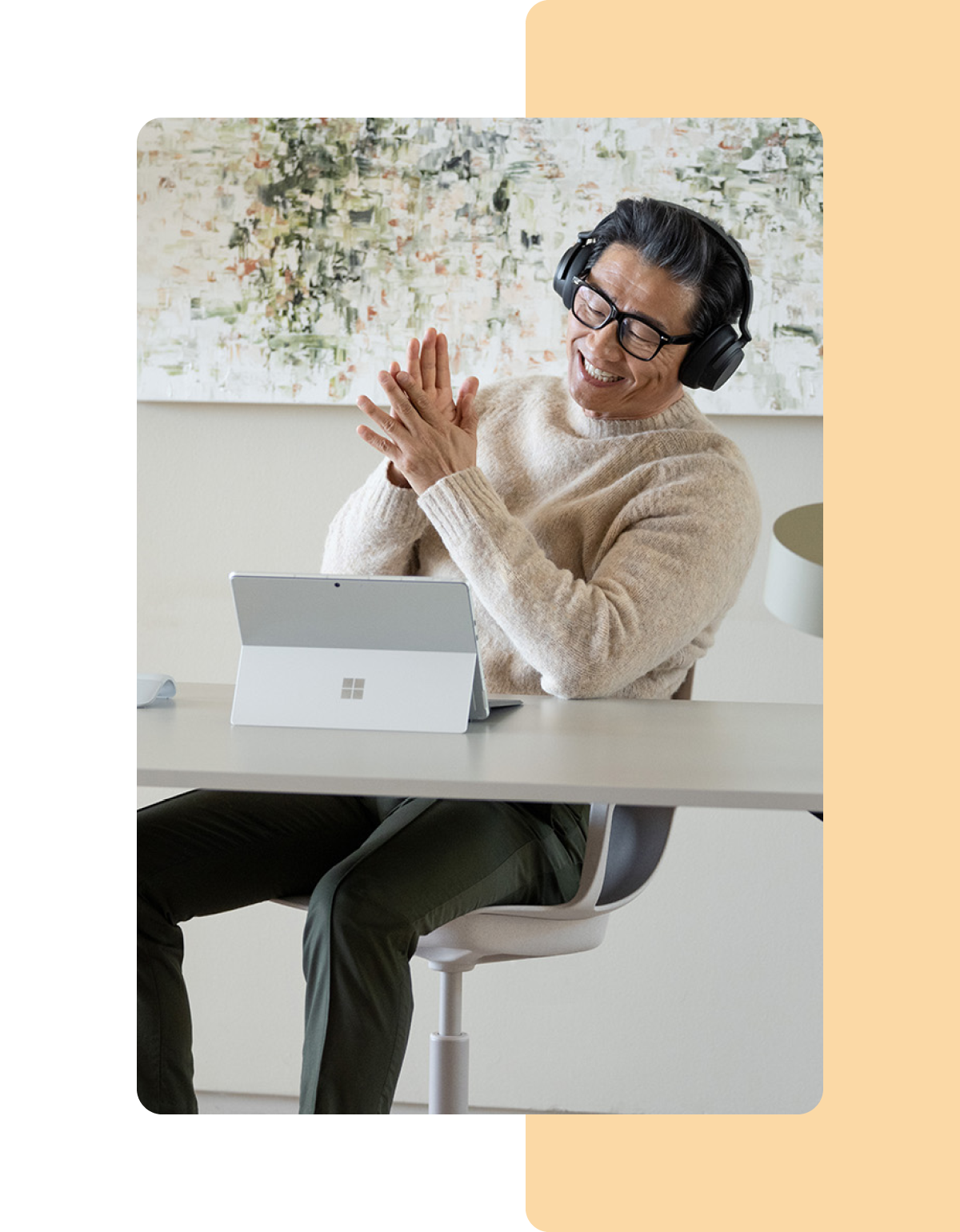 Image of a person working in an office on a Microsoft Surface laptop