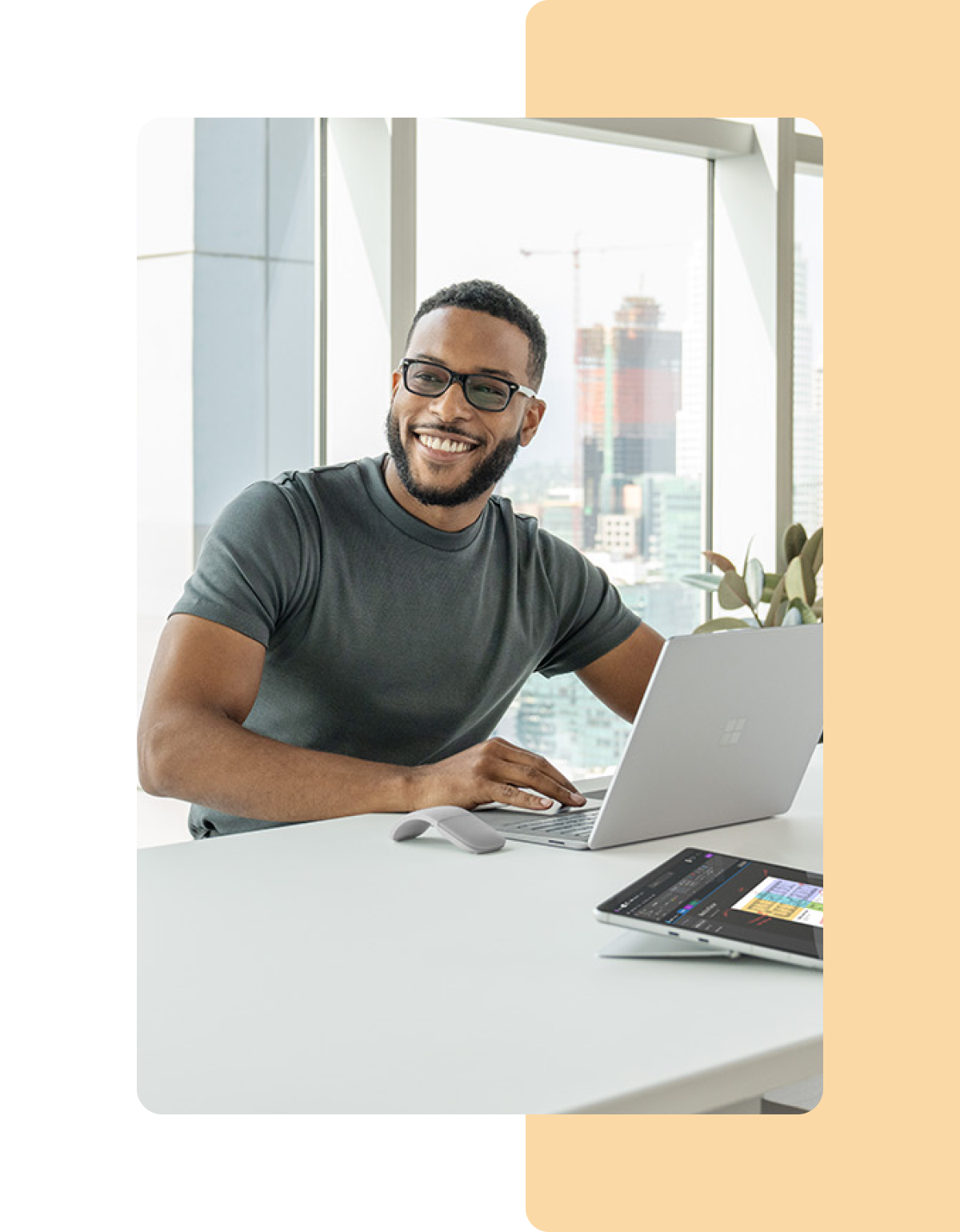 Image of a person working in an office on a Microsoft Surface laptop