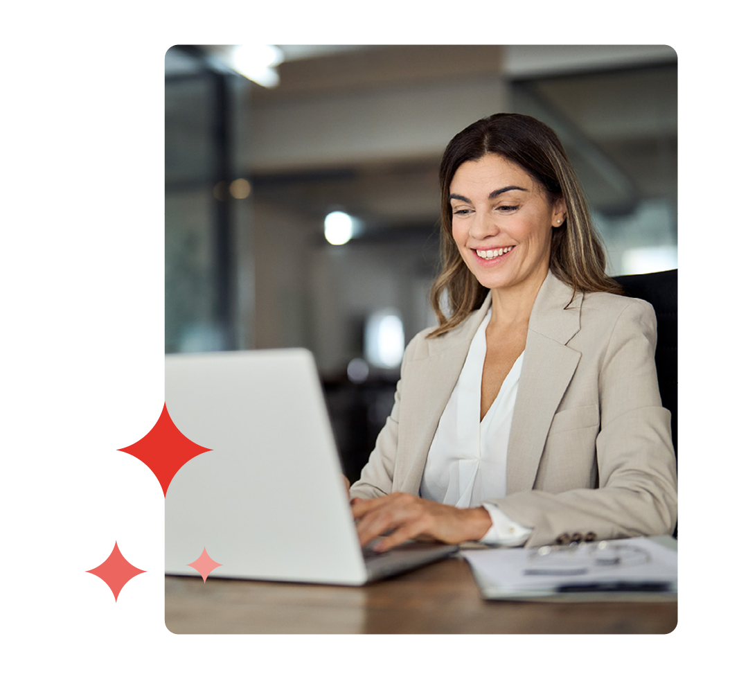 Image of a person working on a laptop at their desk