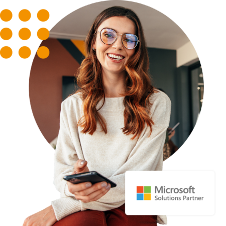 Image of a smiling person in an office environment with our Microsoft Solutions Partner logo