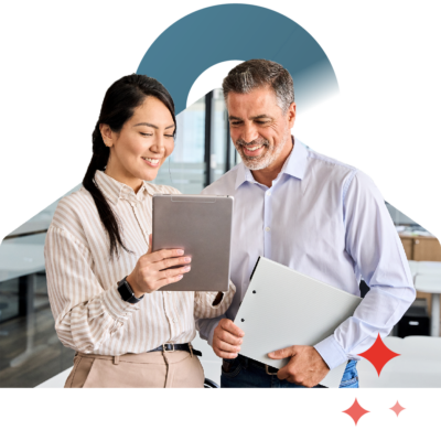 Two people smiling working on a tablet