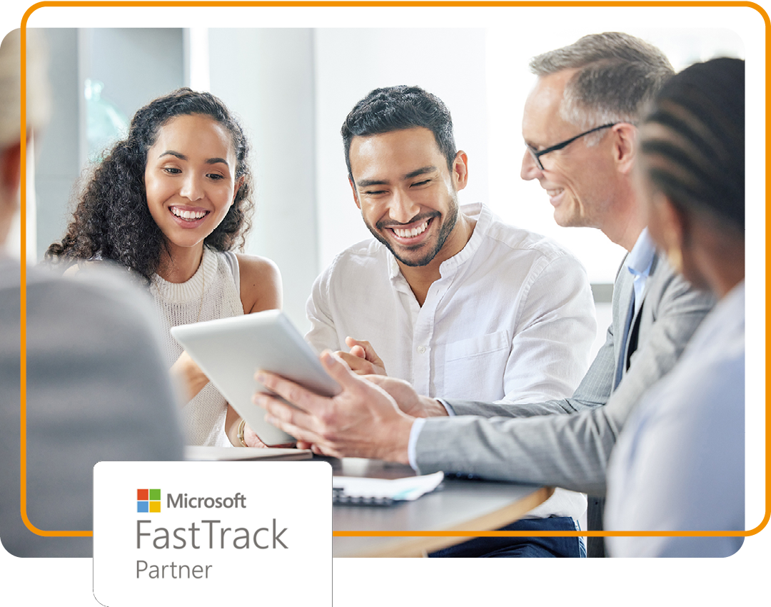 Image of a group of people sat around a desk with Phoenix's Microsoft FastTrack partner logo