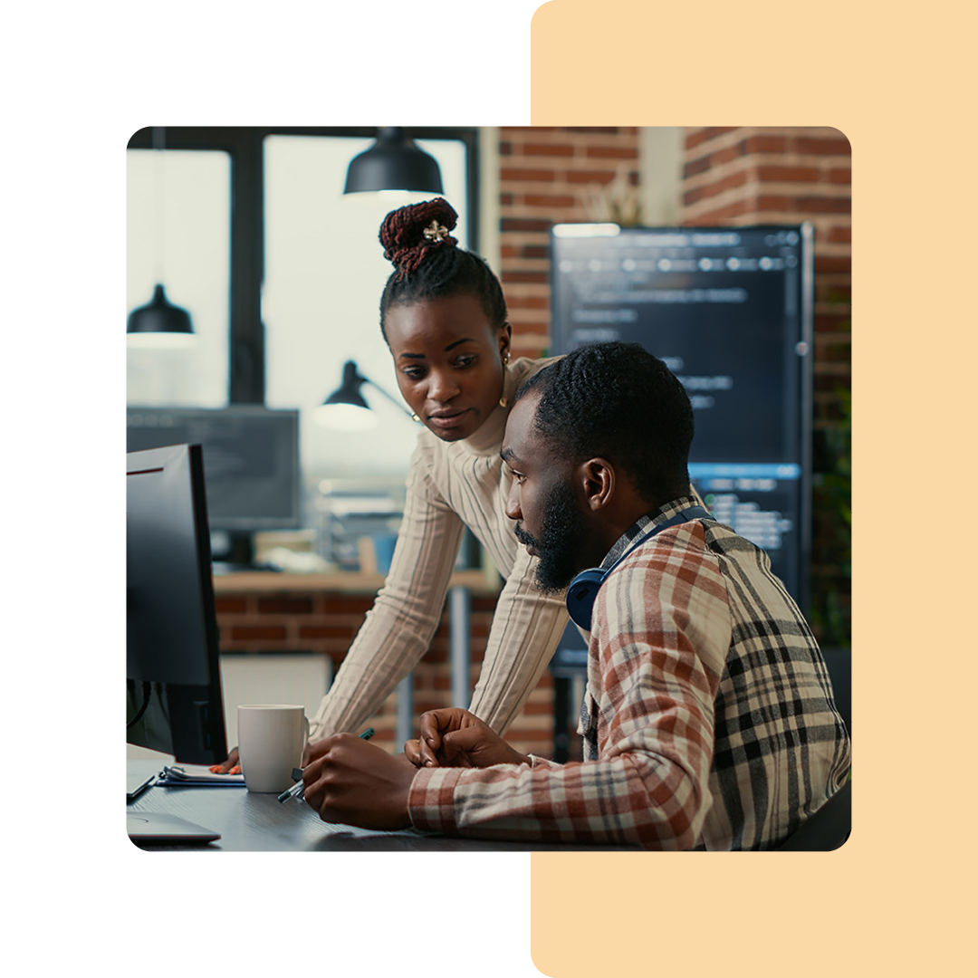 Image of two cyber security professionals working on a computer