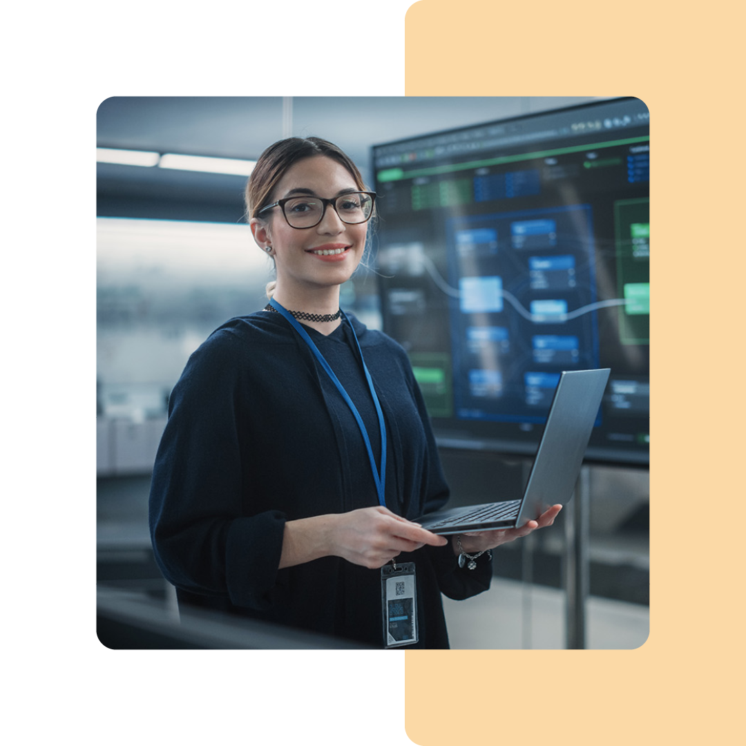 Image of a cyber security professional stood holding a laptop