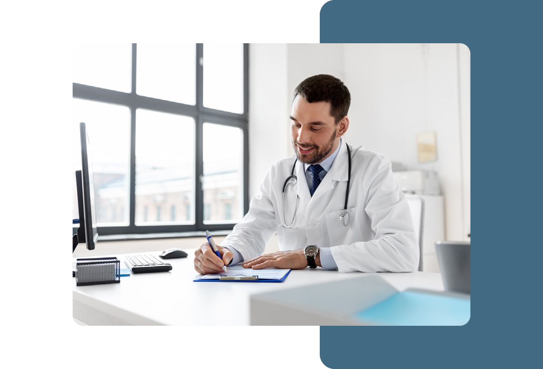 Image of a doctor working at a desk writing on a clipboard