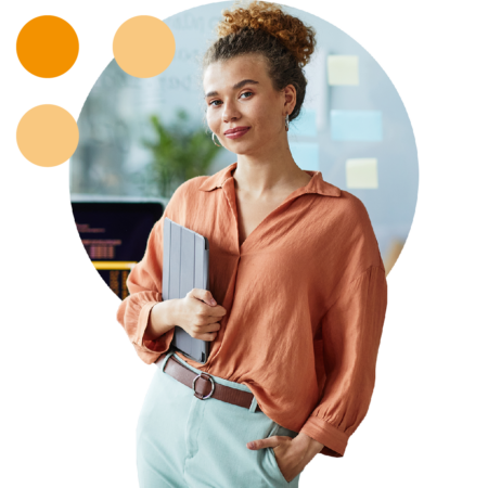 Image of a business person stood holding a tablet in an office