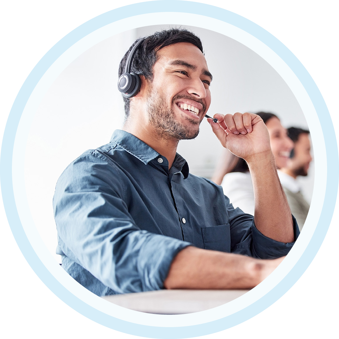 Image of an IT support professional working on a computer with a headset on