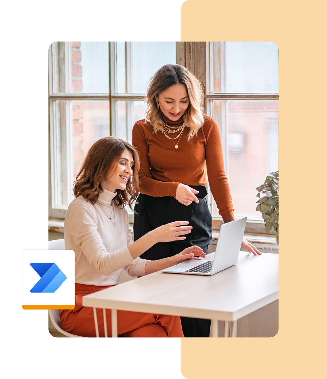 Image of two colleagues working together on a laptop