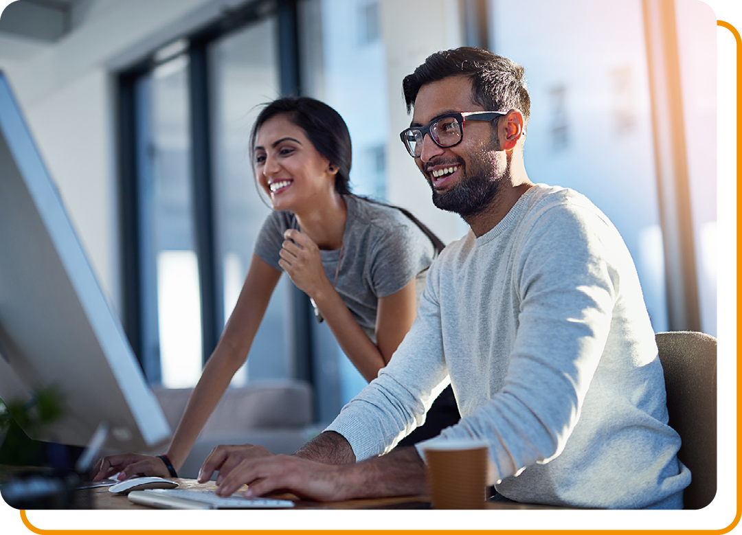 Image of two business professionals working together on a laptop