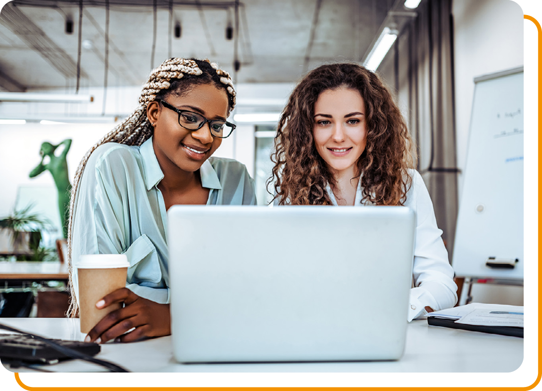 Image of two business professionals working together on a laptop