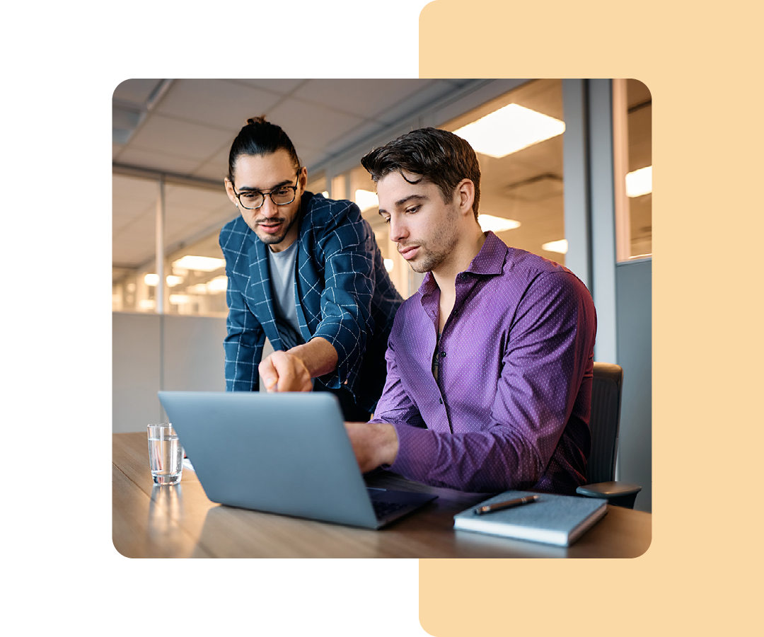 Image of two business professionals working together on a laptop