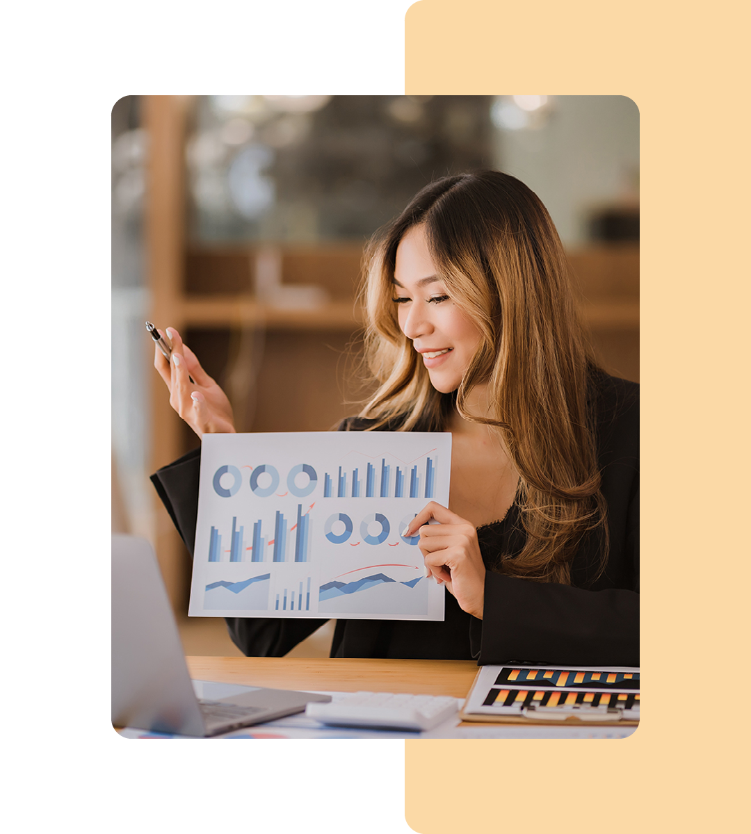 Image of a data analyst holding paper with data on it