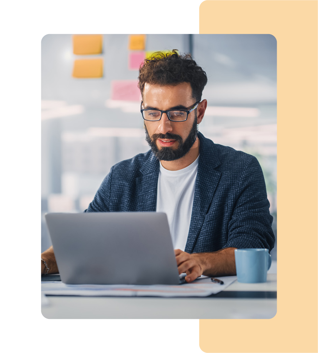 Image of a person working on a laptop in an office environment