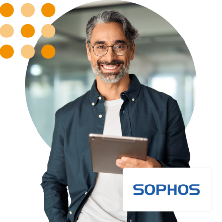 Image of an IT professional stood in an office holding a tablet with the Sophos logo