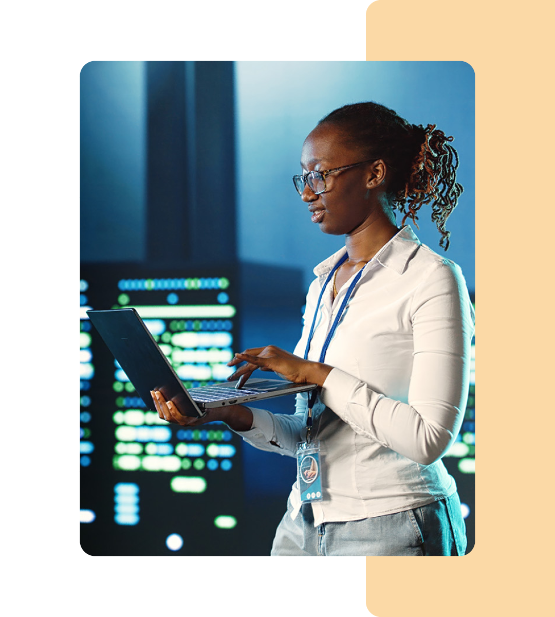 Image of an IT professional walking in a server room holding a tablet