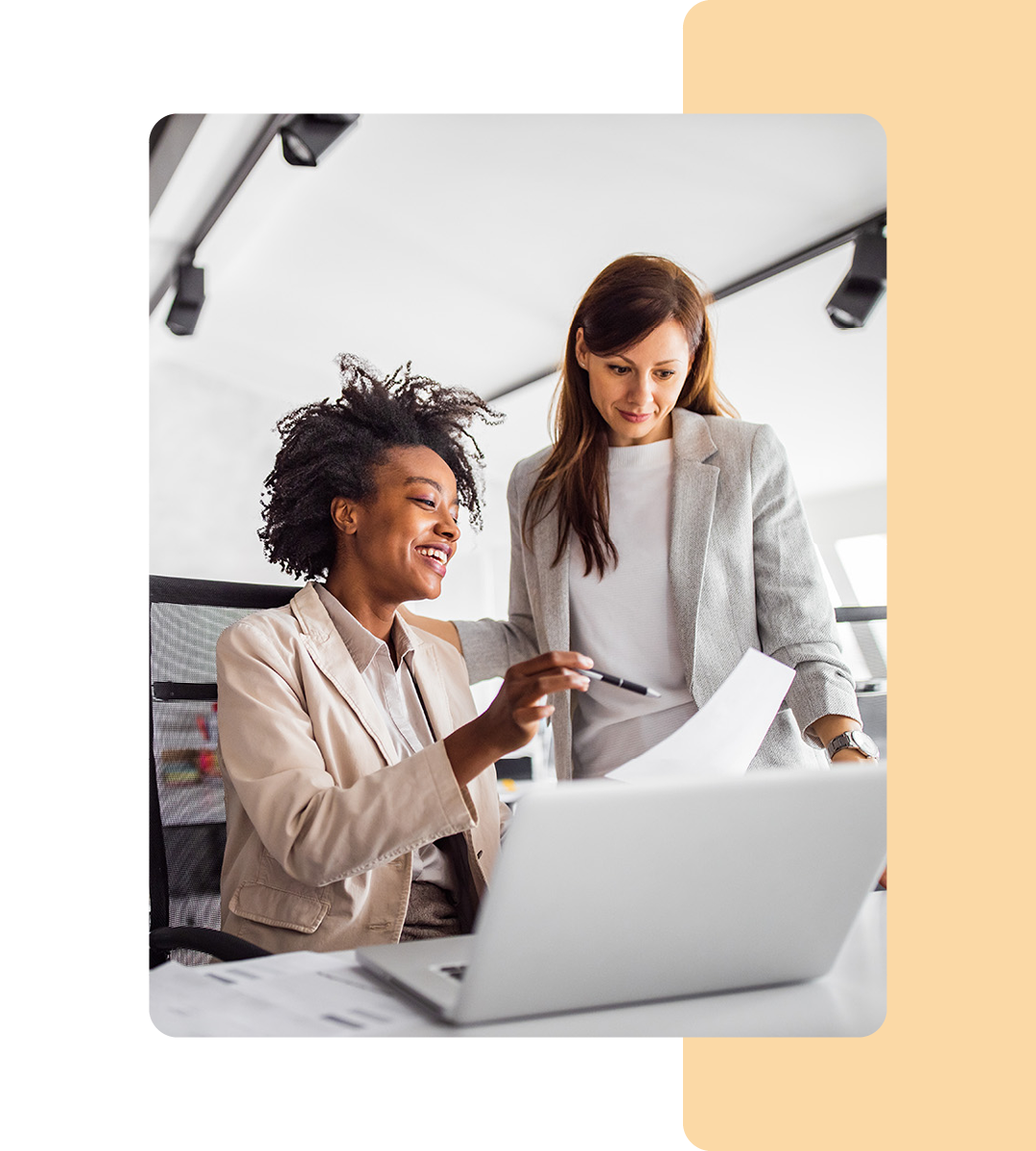 Image of two business professionals working on a laptop