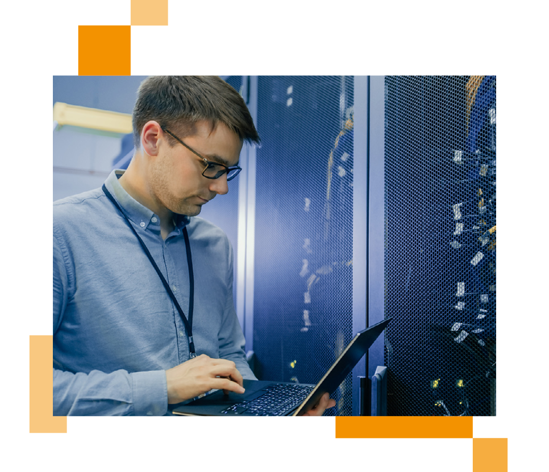 Image of an IT professional stood in a server room