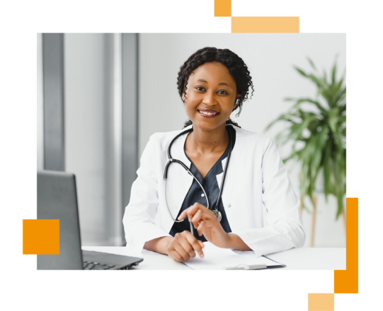 Image of a smiling doctor working at a desk