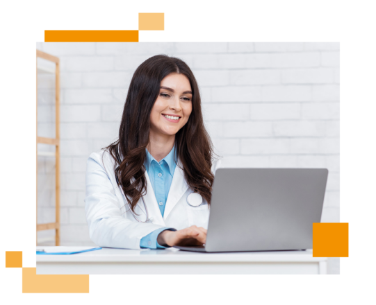 Image of a smiling doctor working on a laptop