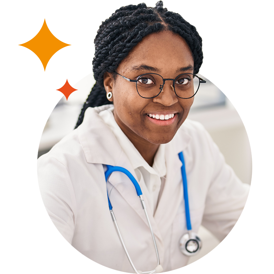 Image of a smiling doctor sat at a desk