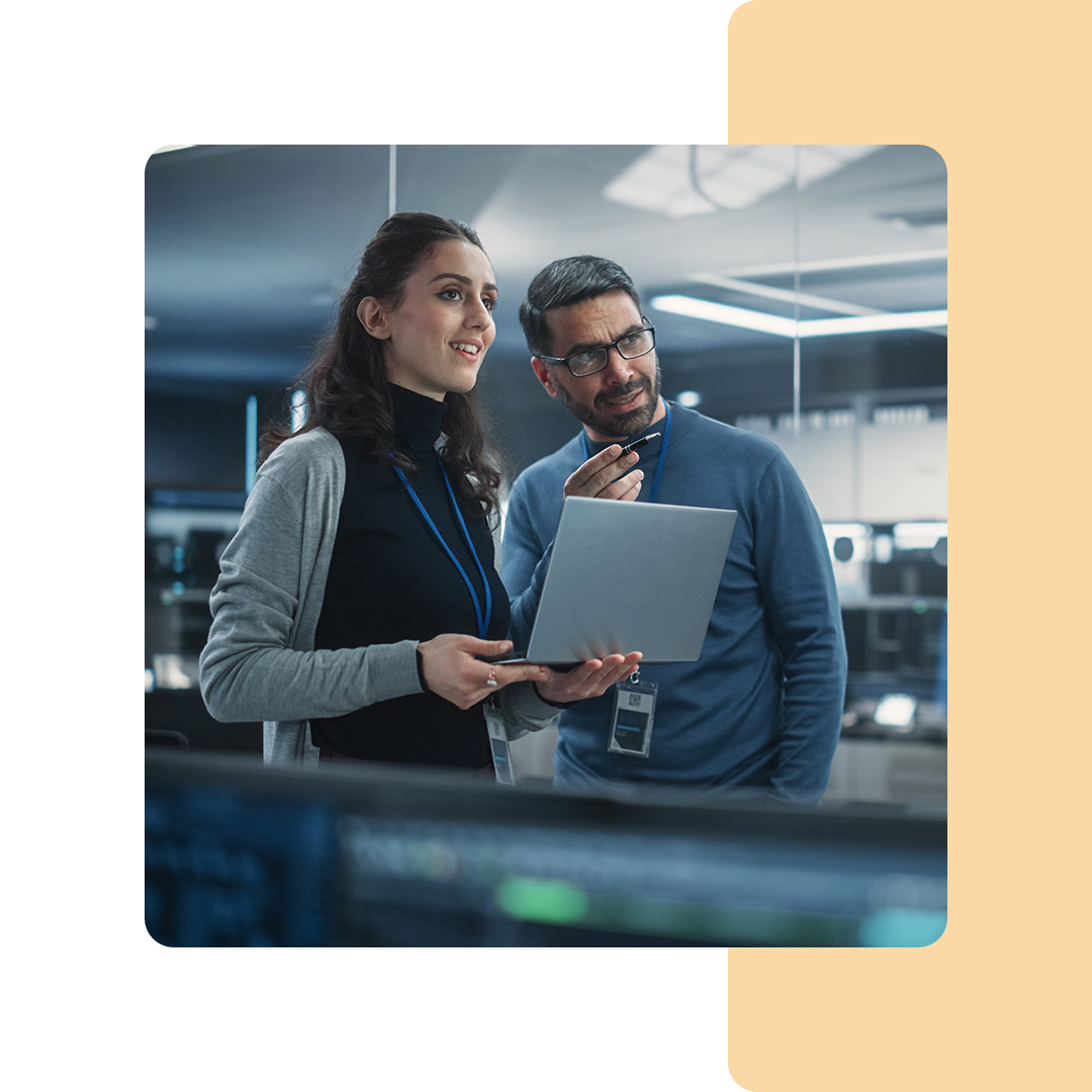 Image of two IT professionals in conversation in a server room