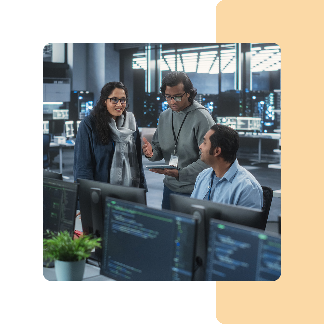 Image of three IT professionals in conversation in an office