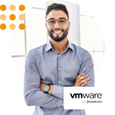 Image of a smiling business professional stood in an office environment with the VMware by Broadcom logo