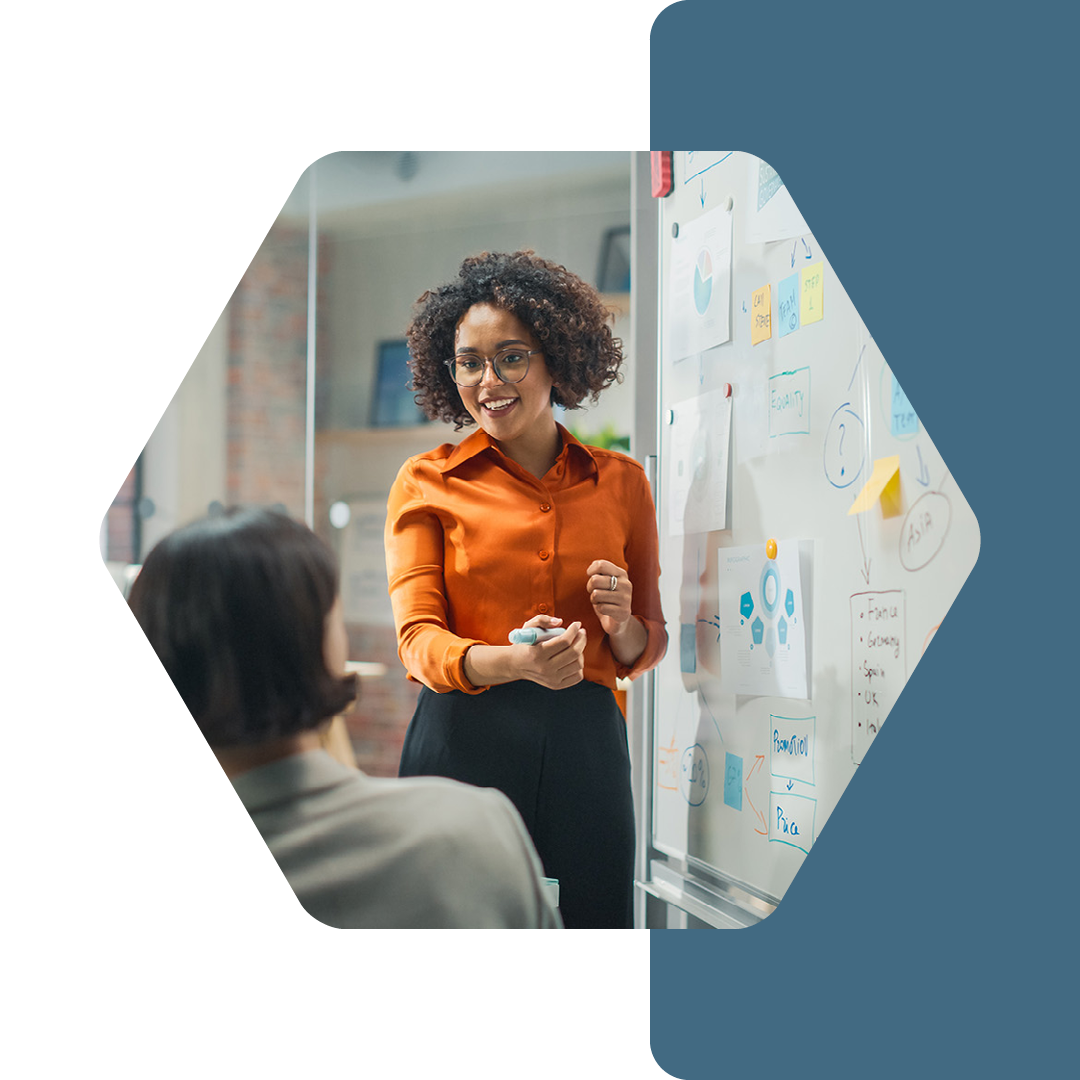 Image of a security professional talking to a group of people while writing on a whiteboard