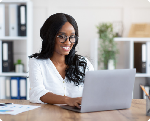 Image of a smiling person working on a laptop