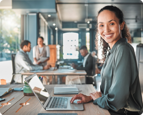 Image of a smiling person working on a laptop