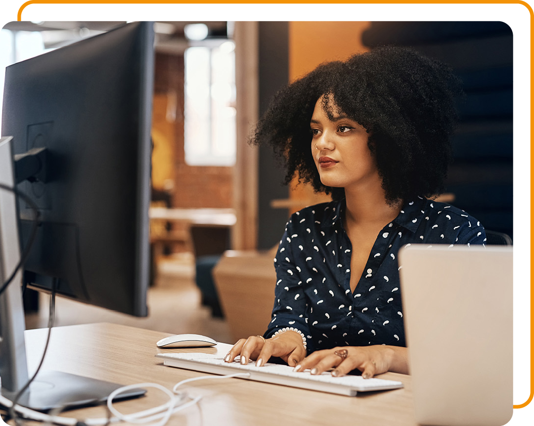 Image of a person working on a computer in an office