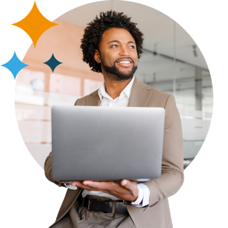 Image of a smiling business professional stood holding a laptop