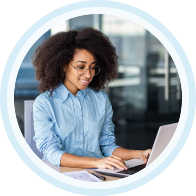 Image of a smiling person working on a laptop