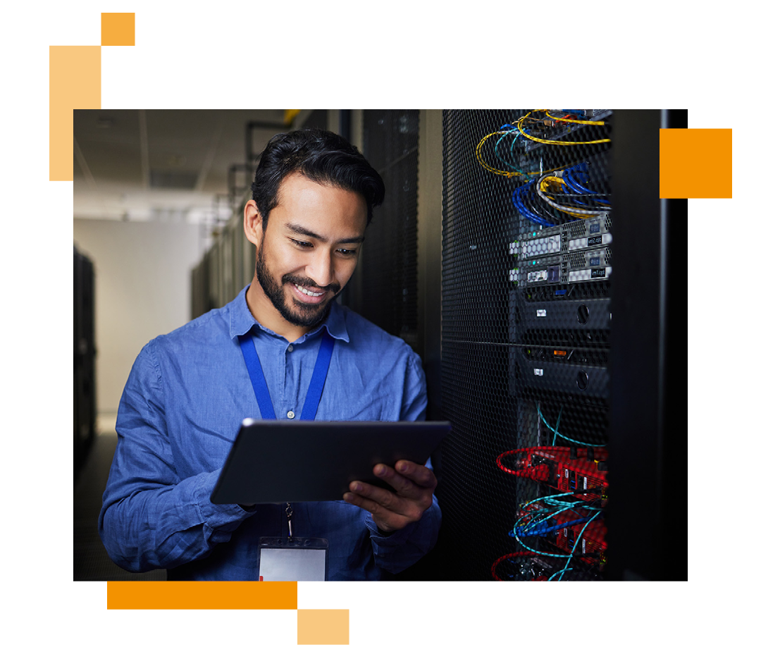 Image of an IT professional working on a tablet in a server room