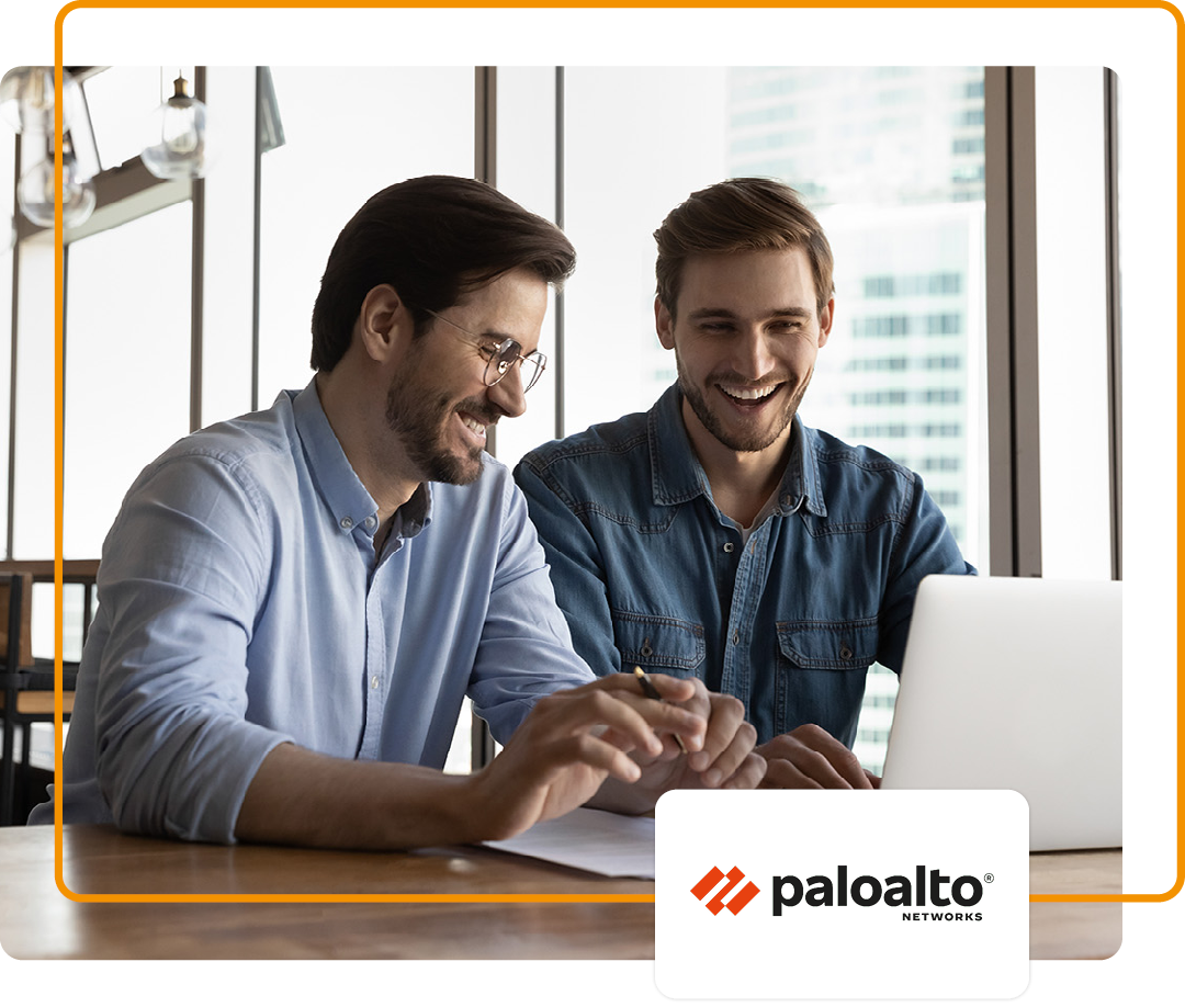 Image of two colleagues sat conversing and working on a laptop with the Palo Alto logo