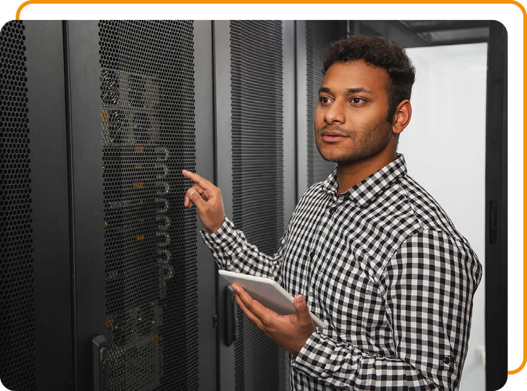 Image of an IT professional working on a tablet in a server room