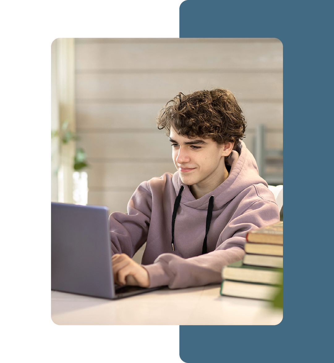 Image of a student working on a laptop in a classroom