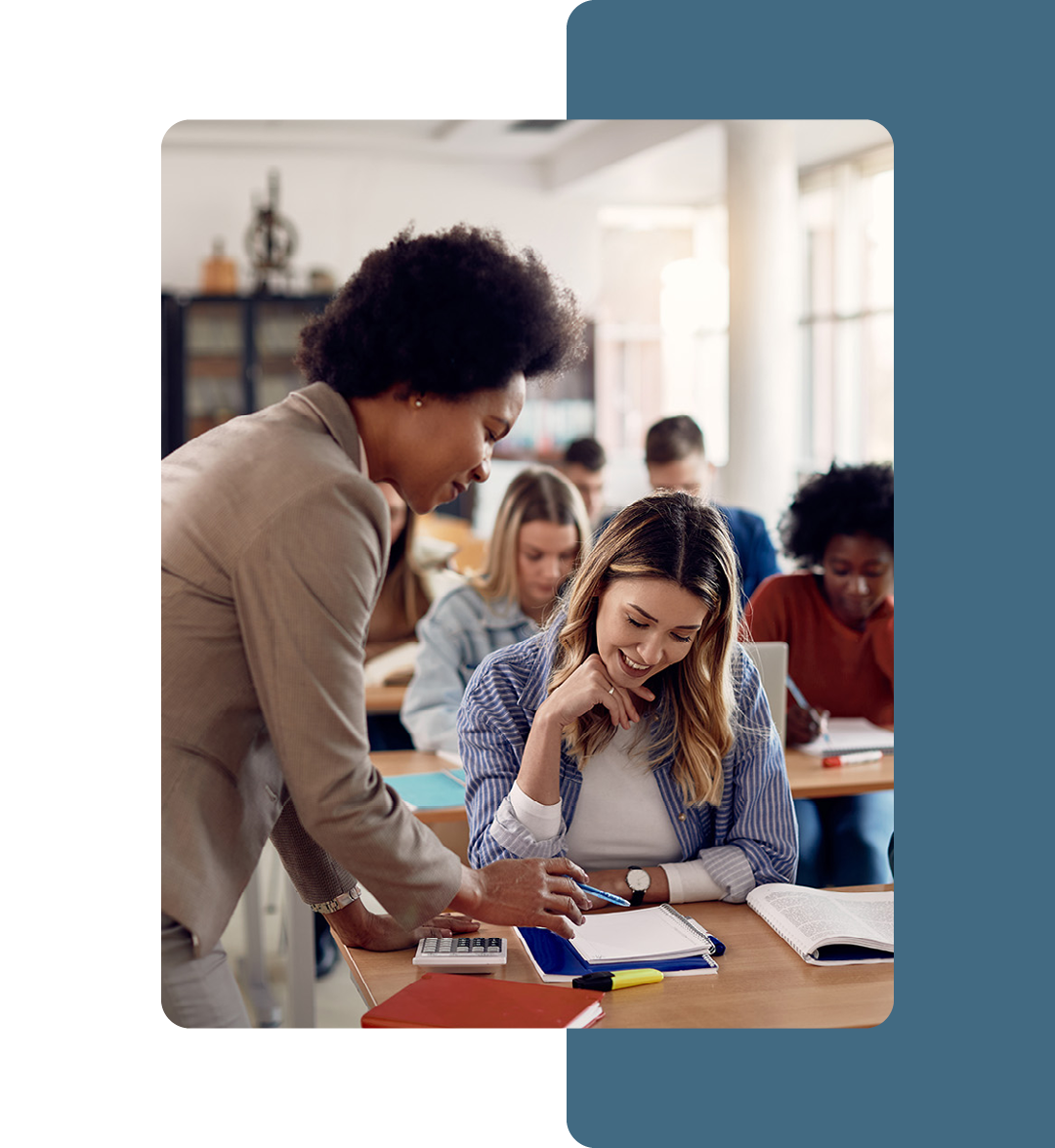 Image of a teacher talking to a student in a classroom