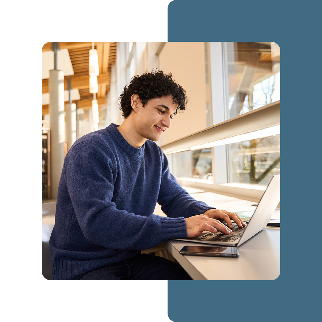 Image of a university student working on a laptop