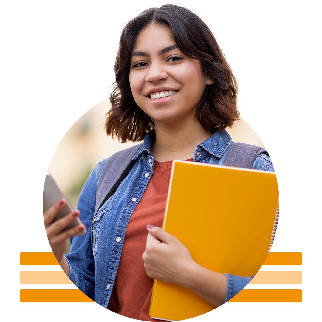 Image of a smiling university student holding notebooks