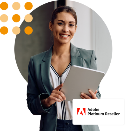 Image of a smiling business person stood in an office holding a tablet with our Adobe Platinum Reseller logo