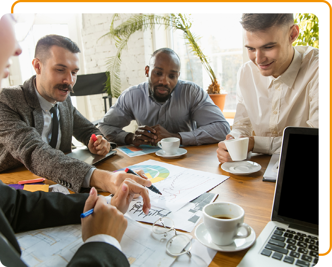 Image of a group of people in a meeting with sustainability information on sheets of paper