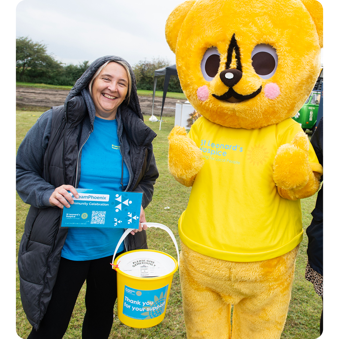 Image of a Phoenix Software employee with the St Leonards Hospice mascot at a Community Event