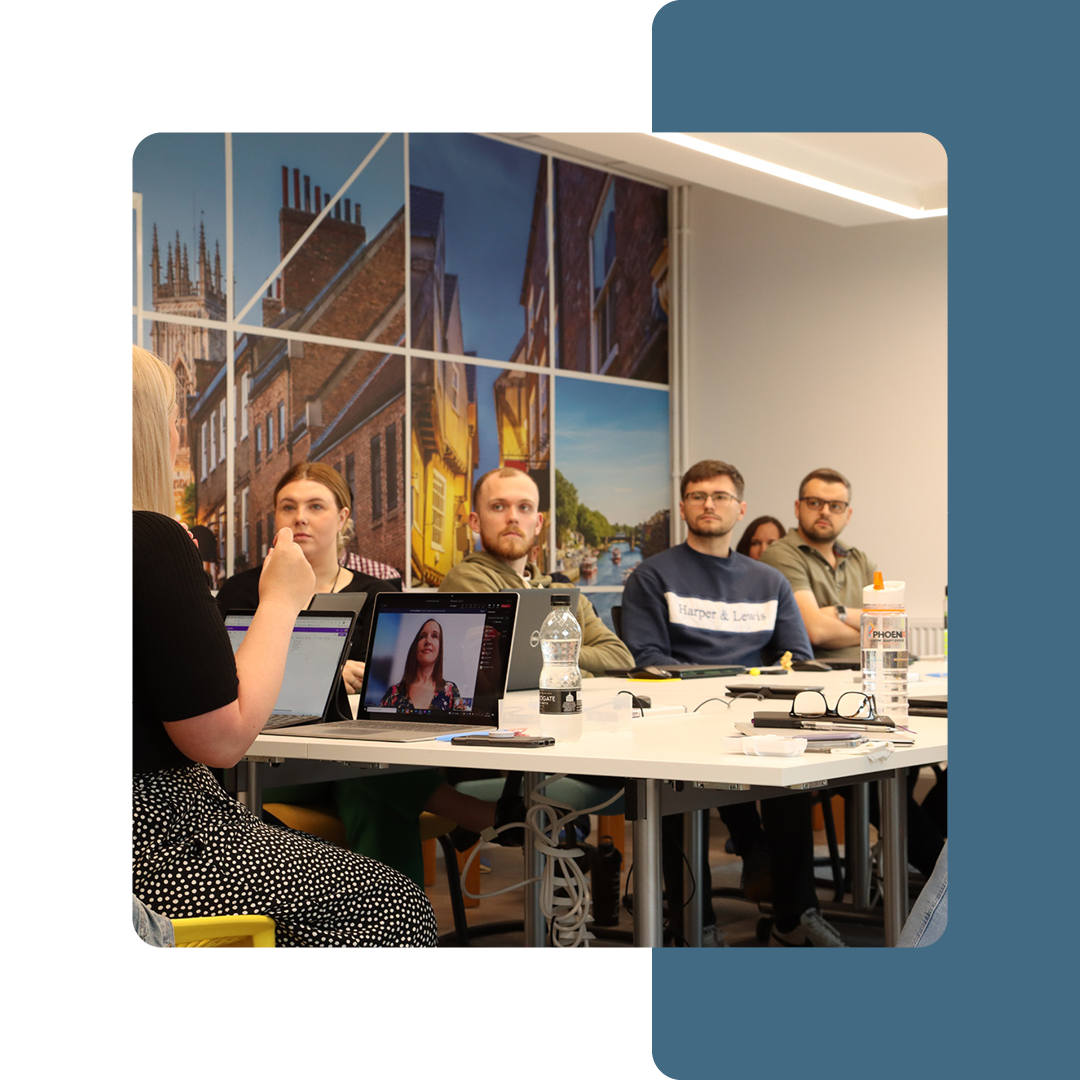 Image of a group of Phoenix Software employees sat in a meeting room